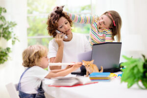 mother working from home with her children because their school is closed