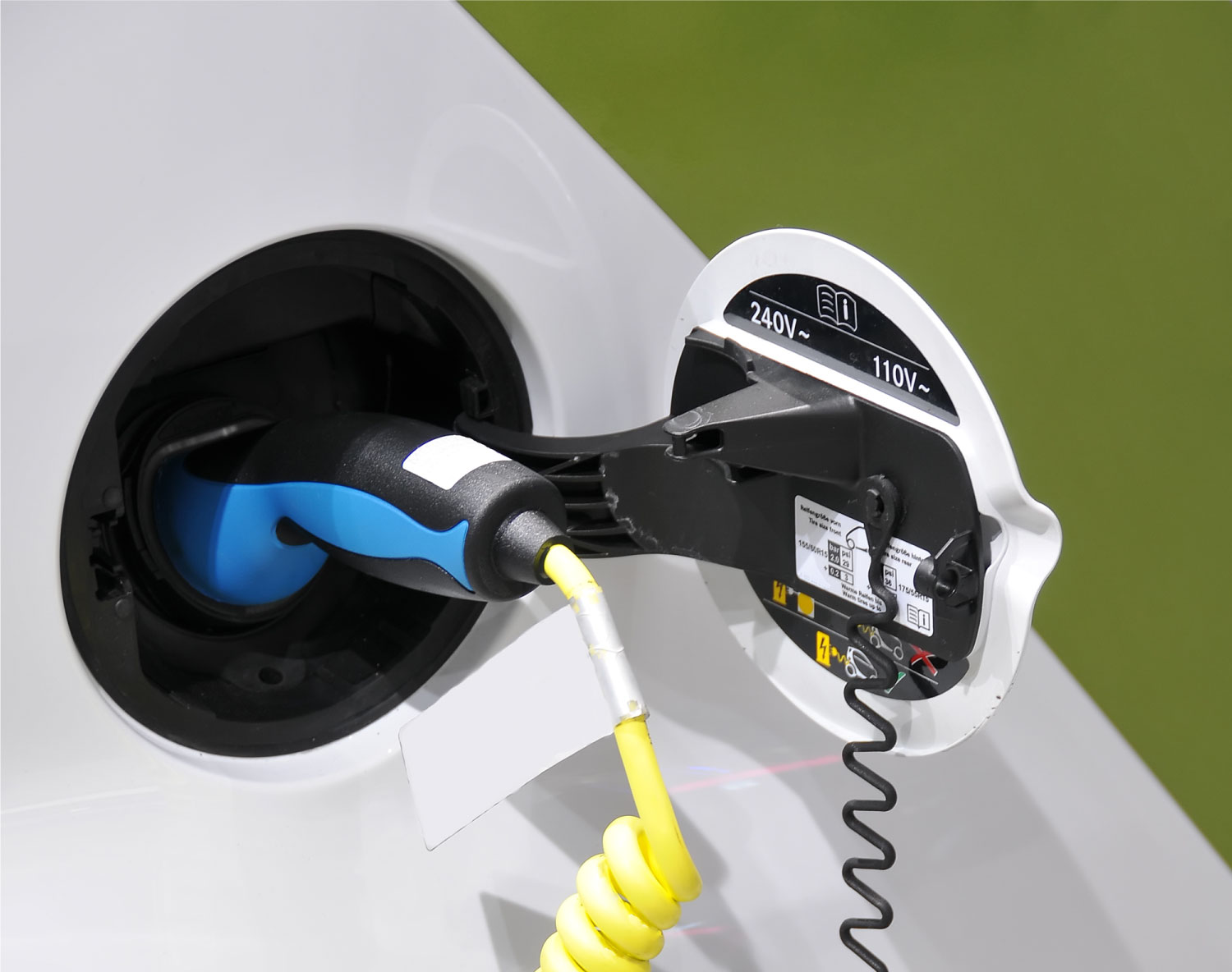 a close up of the charging point of an electric vehicle plugged in for charging