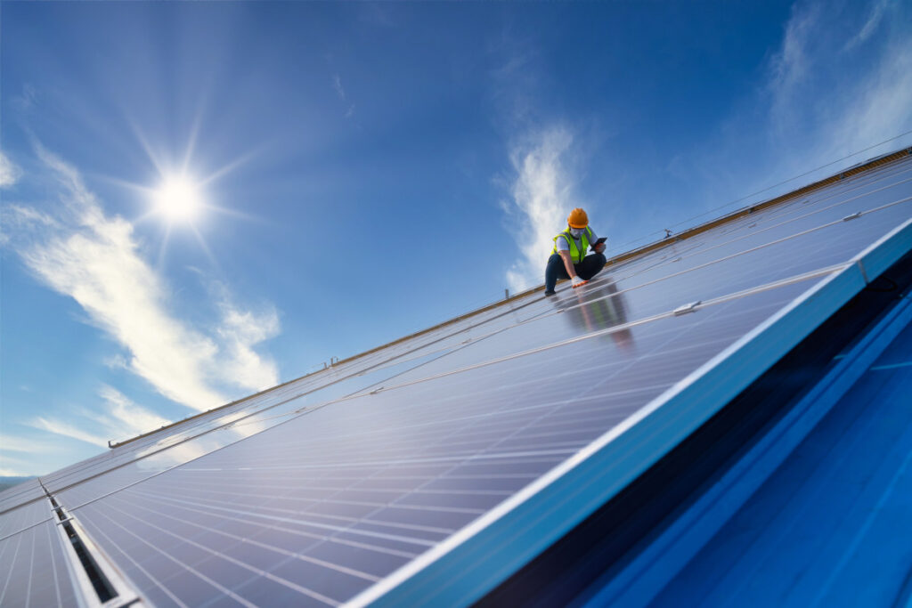 an engineer working on solar panels on a solar farm