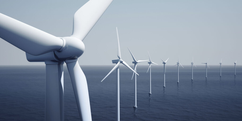 a wind farm - wind turbines out at sea.