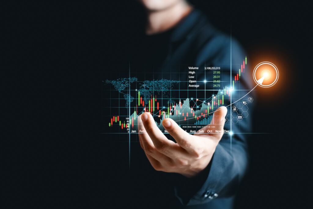 An image of a man’s hand with a graphic of sales data and market growth superimposed onto his hand